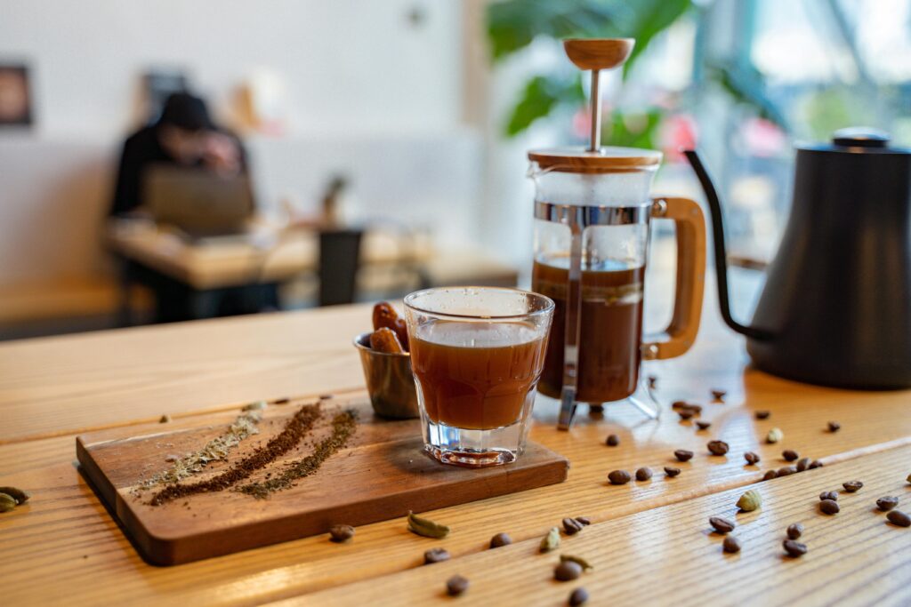 A stylish coffee setup with a French press and spices in a Dubai cafe.
